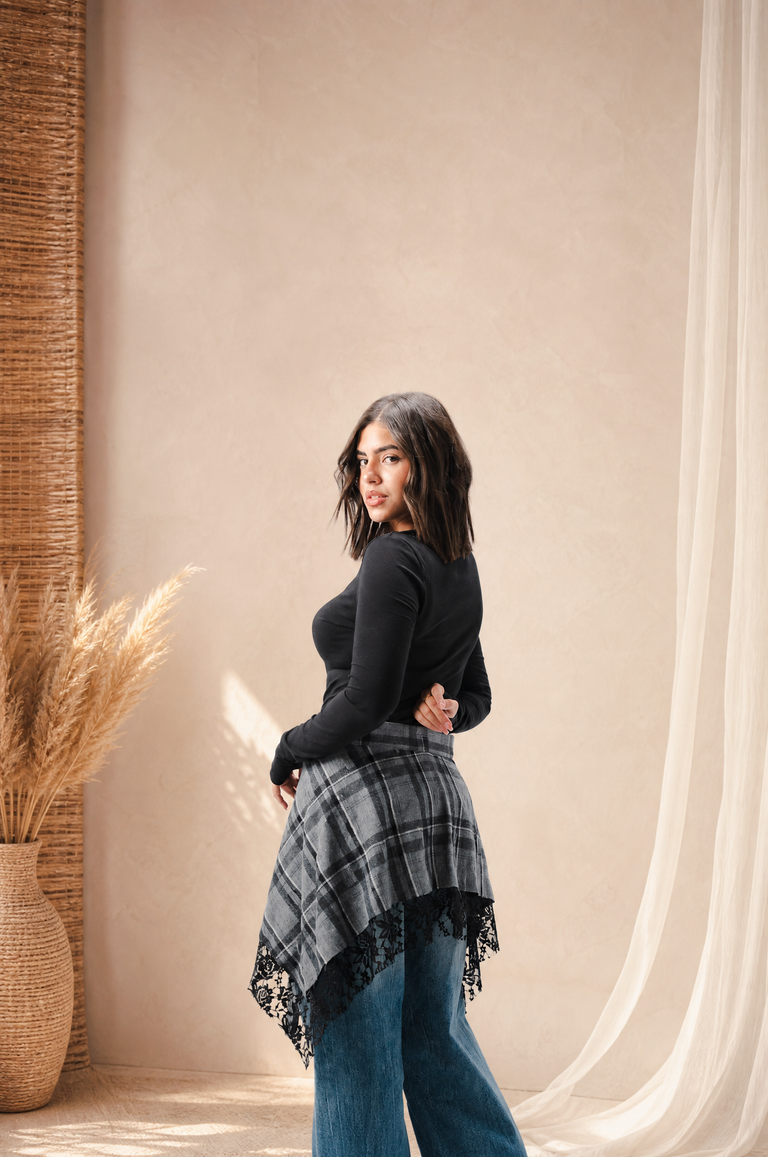 Didi hero - plaid skirt on textured backdrop (desktop)